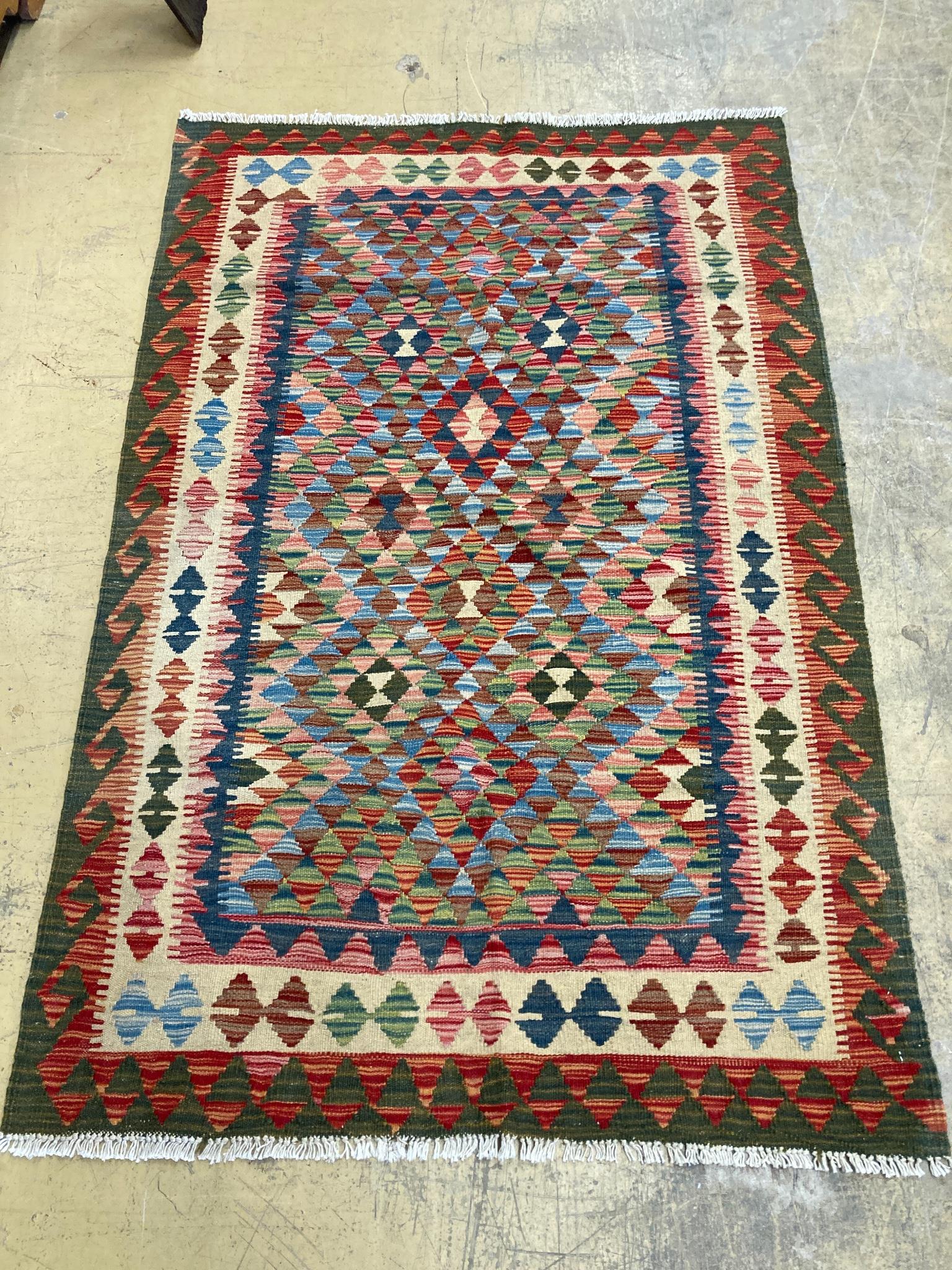 An Afghan multi-coloured geometric patterned kilim rug, 182 x 119cm